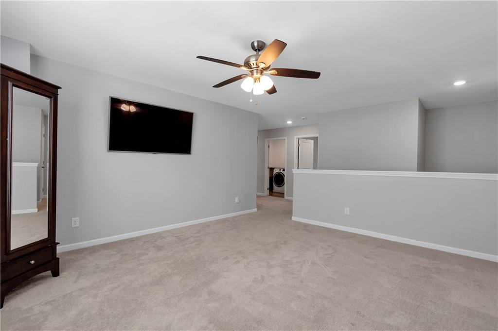660 Groover Street Ball Ground, GA 30107 - Photo 21 of 53 a view of an empty room with a flat screen tv