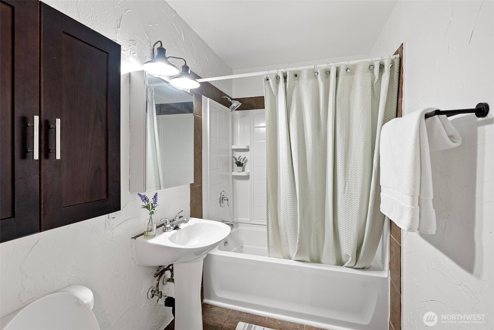 414 Plum Street Bremerton, WA 98310 - Photo 16 of 40 a bathroom with a sink a toilet and a mirror
