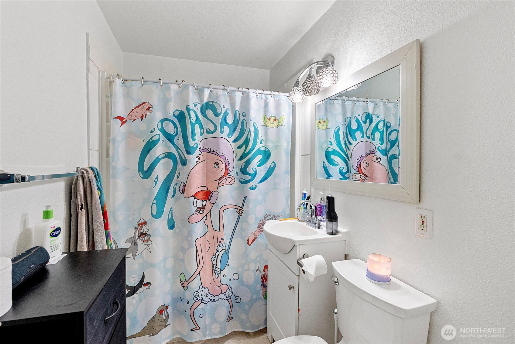 414 Plum Street Bremerton, WA 98310 - Photo 26 of 40 a bathroom with a sink a mirror and a shower curtain