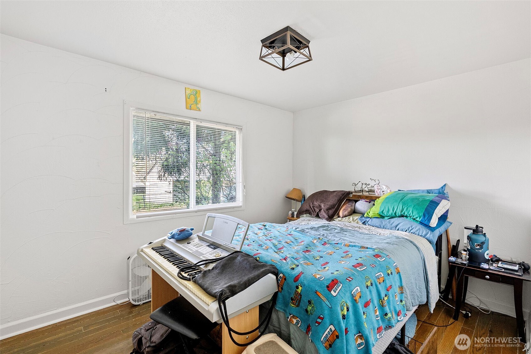 414 Plum Street Bremerton, WA 98310 - Photo 28 of 40 a bedroom with a bed and wooden floor
