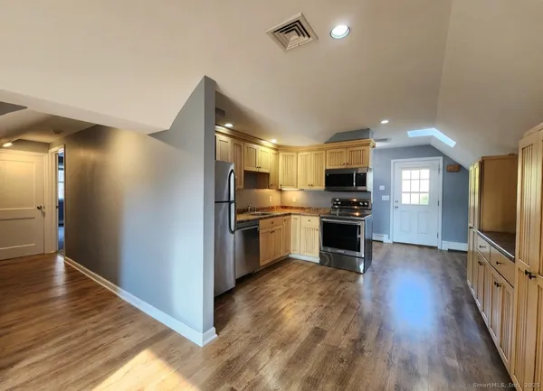 a view of kitchen with sink microwave and refrigerator