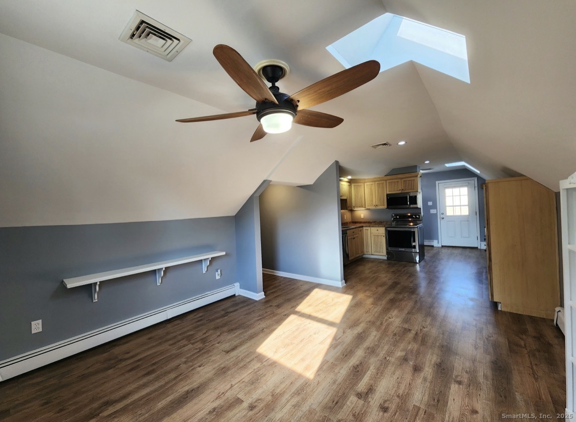 4994 Madison Avenue Trumbull, CT 06611 - Photo 10 of 22 Airy, open living room with vaulted ceiling and skylight