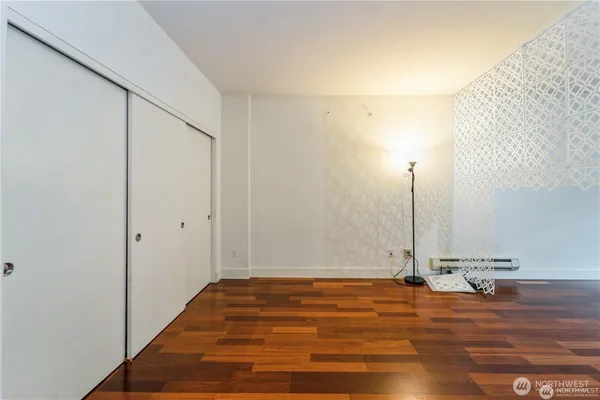 a view of a room with wooden floor