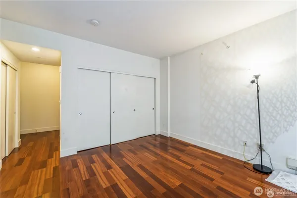 a view of a room with wooden floor and bathroom