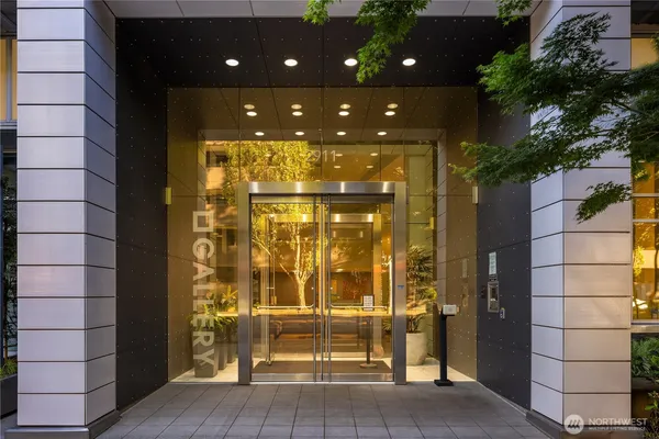 a bathroom with a glass shower door and a glass door