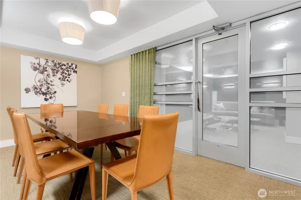 a view of a dining room with furniture and a chandelier