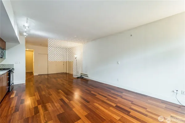 a view of an empty room and wooden floor