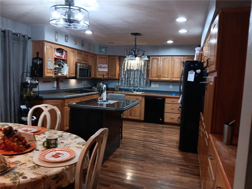 206 8th Avenue Butler, PA 16001 - Photo 6 of 20 a kitchen with stainless steel appliances wooden floor dining table and chairs