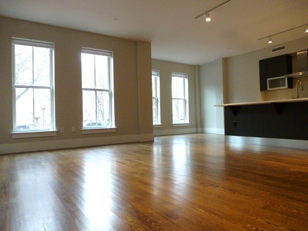 10 St George Street, Unit 103 Boston, MA 02118 - Photo 1 of 8 a view of an empty room with wooden floor and a window