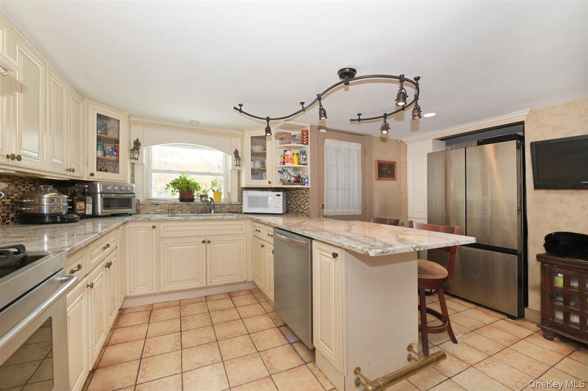6 Callahan Road Fort Salonga, NY 11768 - Photo 13 of 50 a kitchen with a stove a sink and a refrigerator
