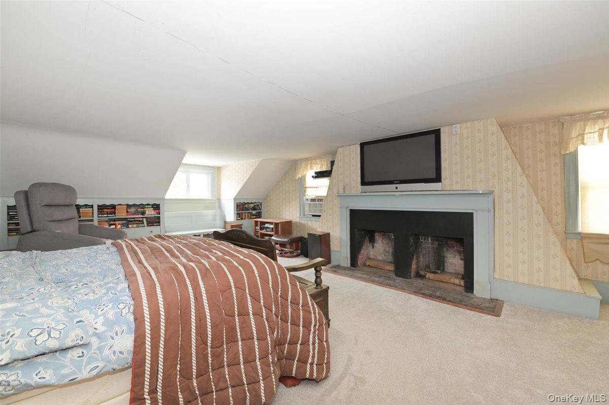 6 Callahan Road Fort Salonga, NY 11768 - Photo 19 of 50 a bed room with two beds and a fireplace