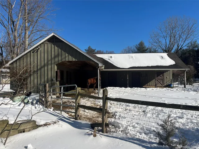 a view of a house with wooden fence