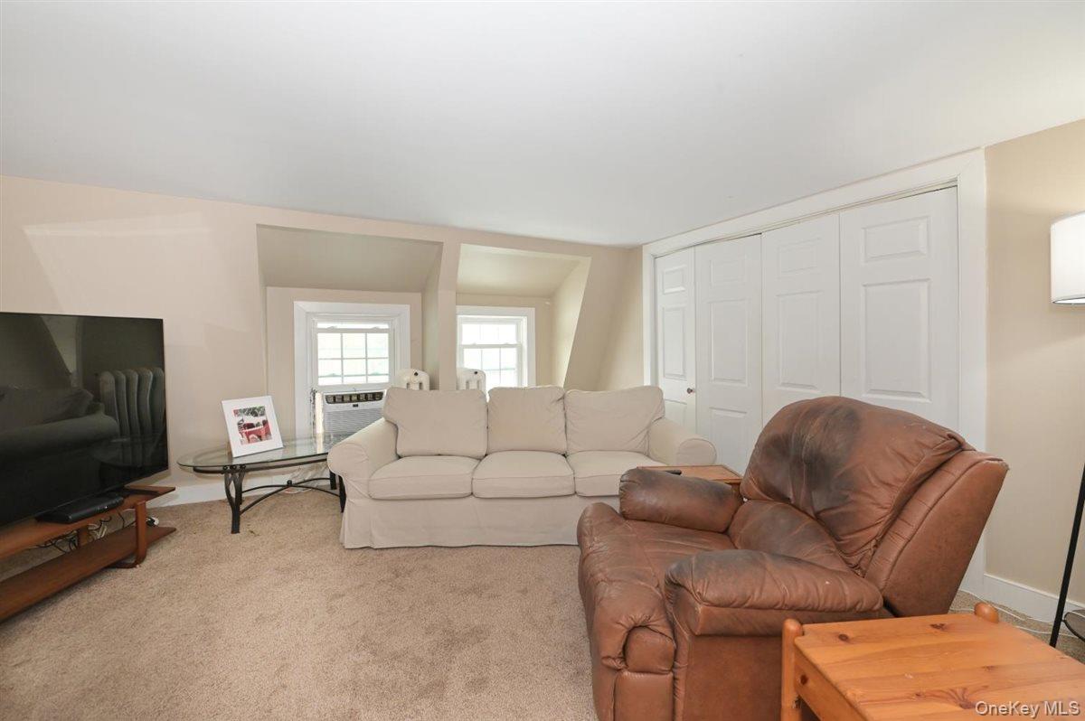 6 Callahan Road Fort Salonga, NY 11768 - Photo 25 of 50 a living room with furniture and a flat screen tv