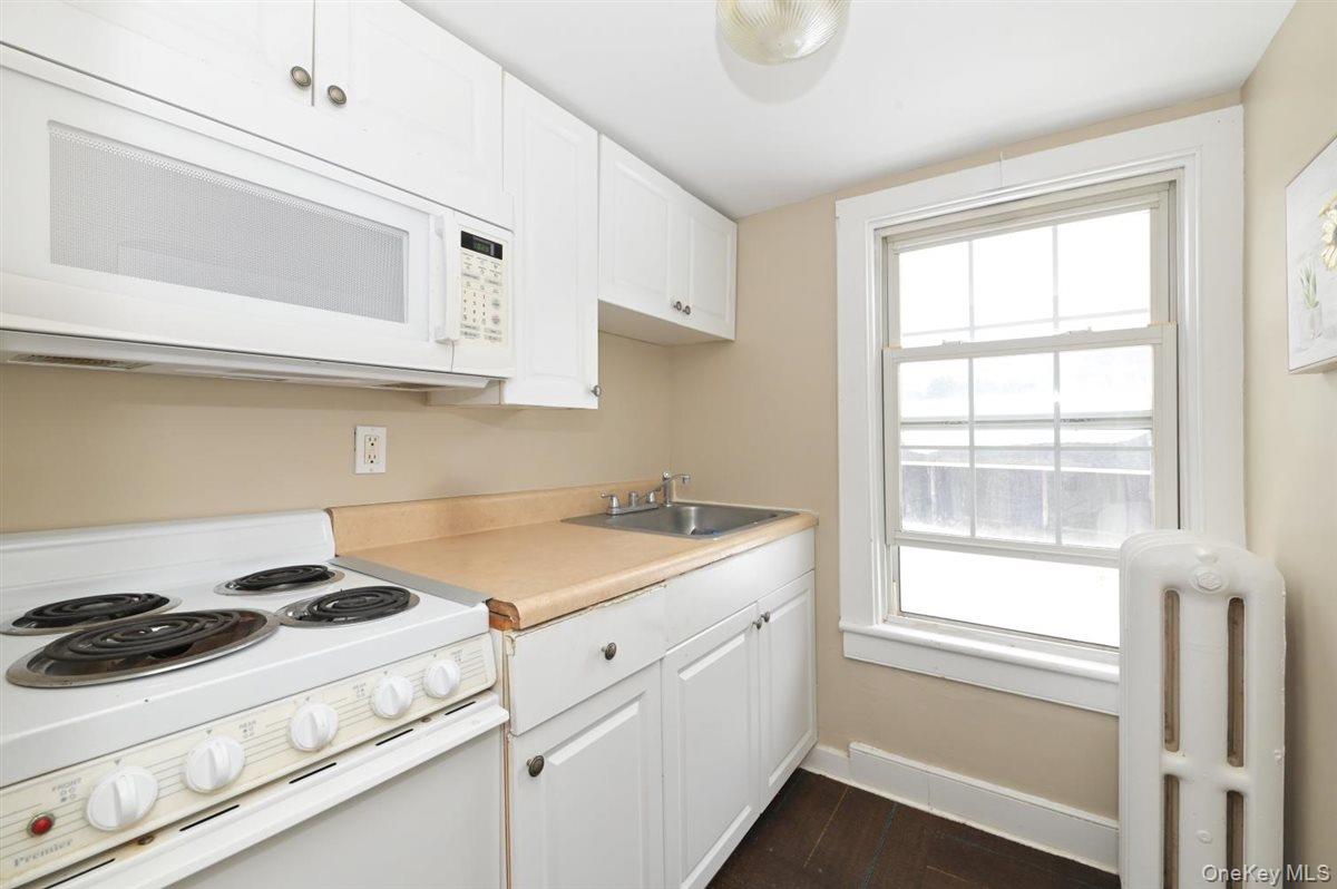 6 Callahan Road Fort Salonga, NY 11768 - Photo 26 of 50 a kitchen with a stove and a microwave