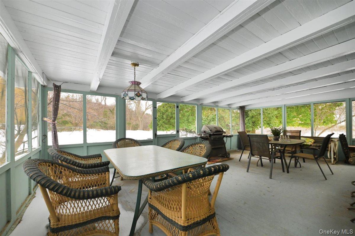 6 Callahan Road Fort Salonga, NY 11768 - Photo 28 of 50 a dining room with furniture large windows and a chandelier