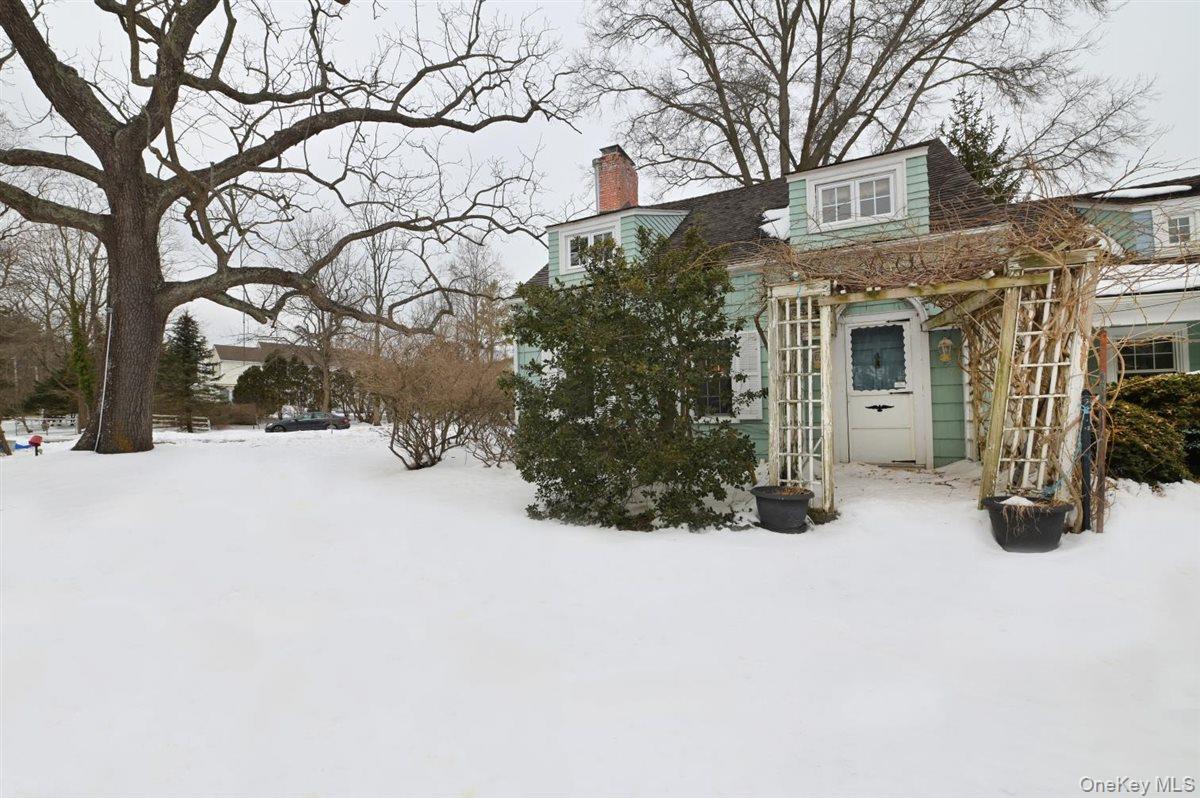6 Callahan Road Fort Salonga, NY 11768 - Photo 5 of 50 a view of a house with a yard covered in snow