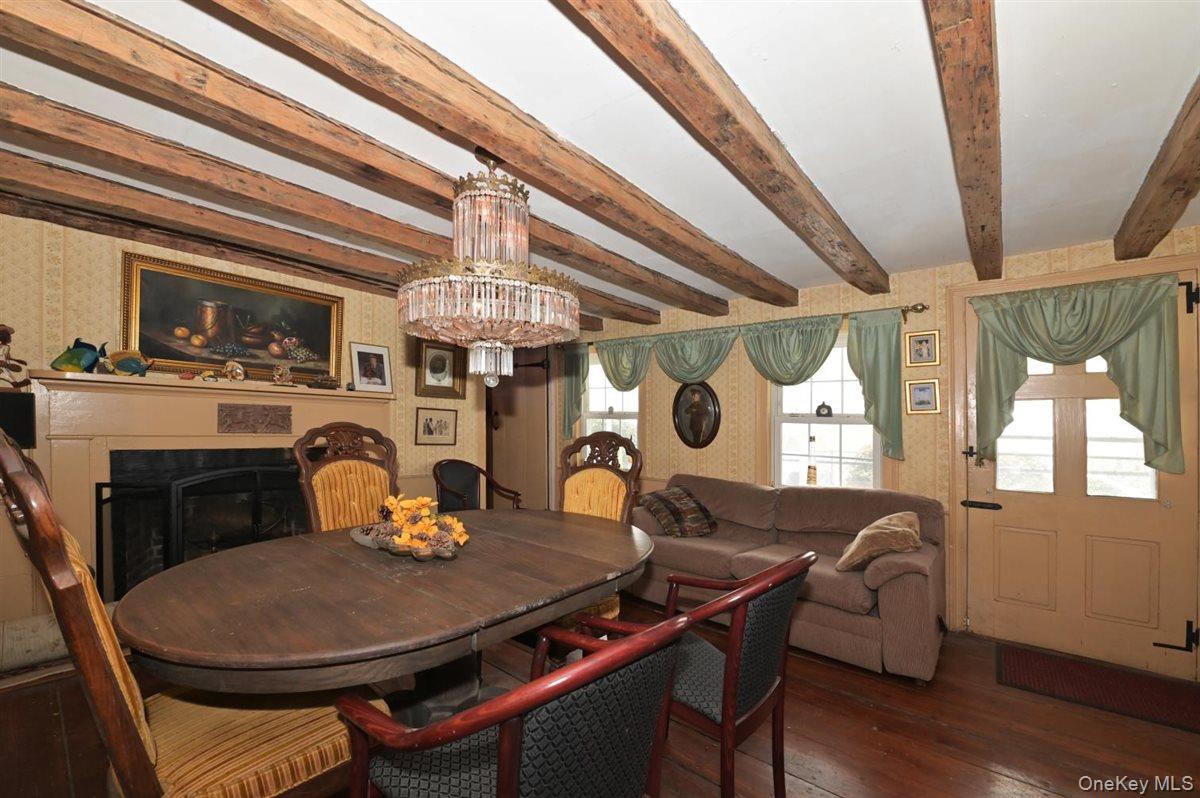 6 Callahan Road Fort Salonga, NY 11768 - Photo 8 of 50 a dining room with wooden floor a chandelier a wooden table and chairs