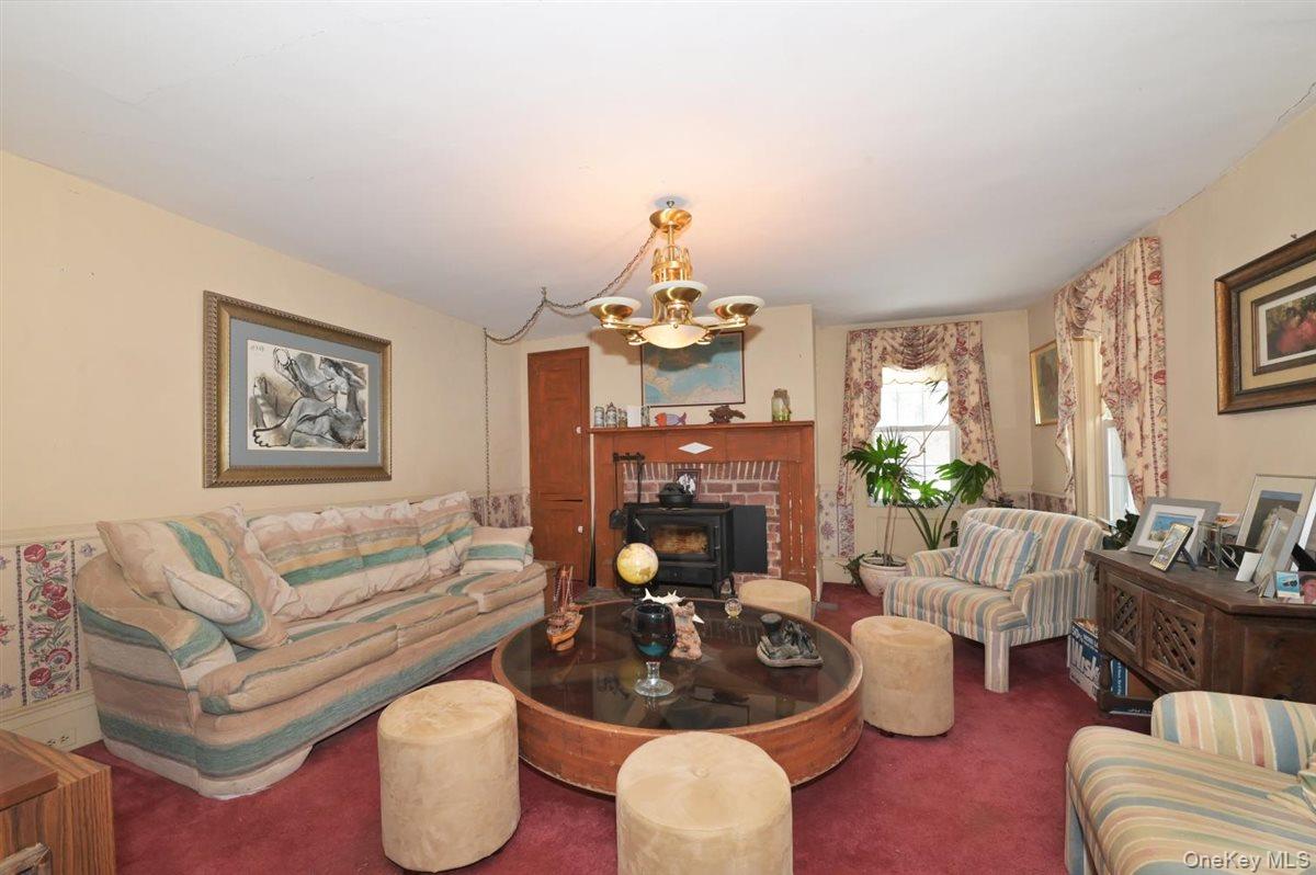 6 Callahan Road Fort Salonga, NY 11768 - Photo 10 of 50 a living room with furniture and a chandelier