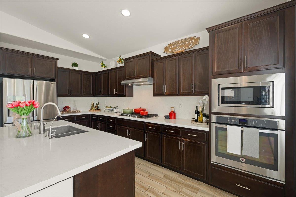1188 Viognier Way Gilroy, CA 95020 - Photo 30 of 71 a kitchen with granite countertop a sink cabinets and stainless steel appliances
