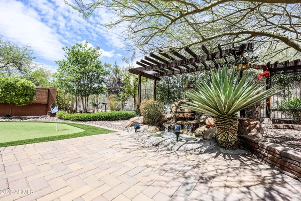 a view of a yard with plants and trees