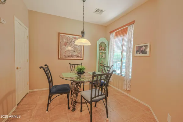 a view of a dining room with furniture and window