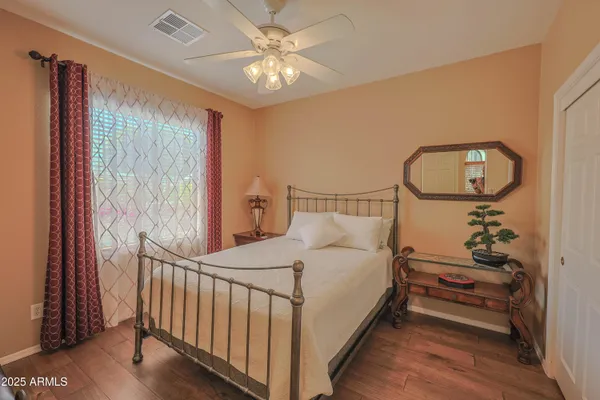 a bedroom with a bed and a chandelier