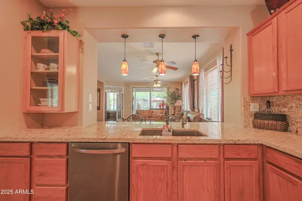 a kitchen with granite countertop a sink cabinets and window