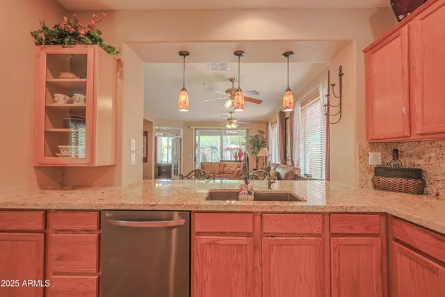 a kitchen with granite countertop a sink cabinets and window