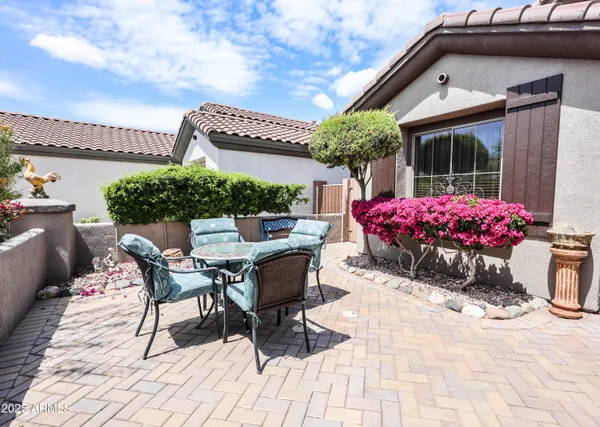 a patio with table and chairs