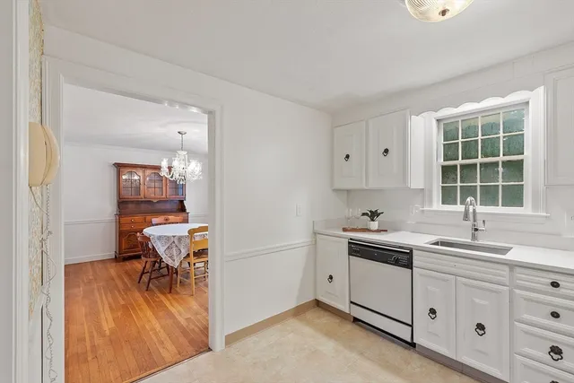 a view of a kitchen with a sink and dishwasher next to a window
