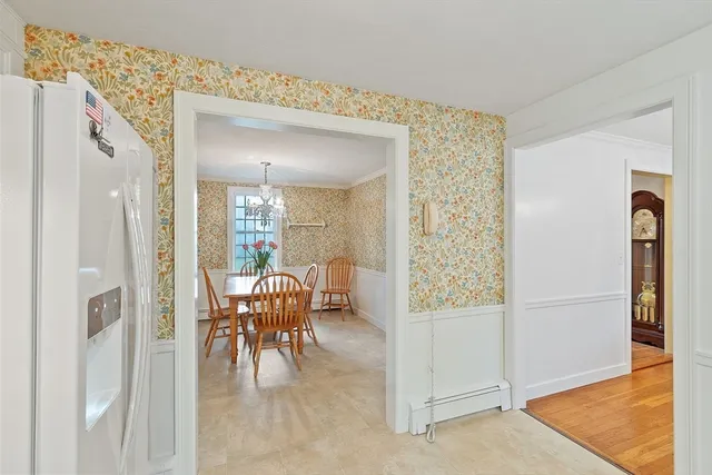 a view of a dining room with furniture and a chandelier