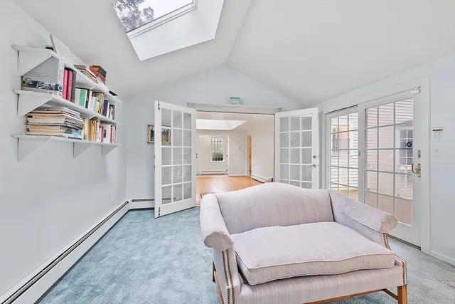 a spacious bedroom with a bed and a large window