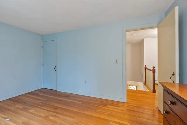 a view of room with window and wooden floor
