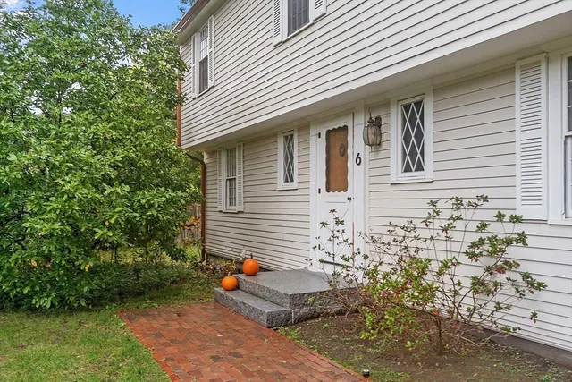 a view of a house with a yard and sitting area
