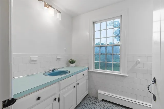 a white house that has a tree in front of it