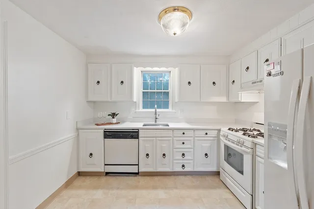 a kitchen with stainless steel appliances a stove a sink and a refrigerator