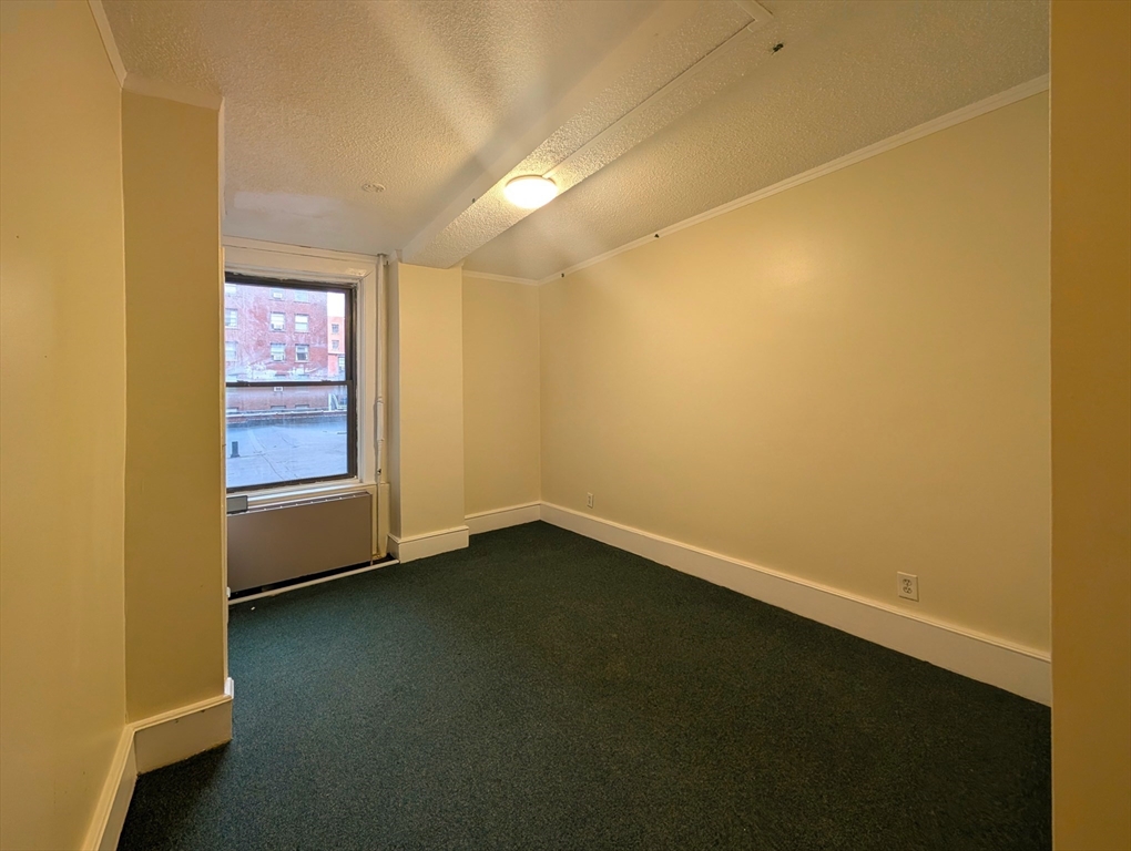 140 Chestnut Street, Unit 207 Springfield, MA 01103 - Photo 10 of 13 an empty room with a empty space and a window