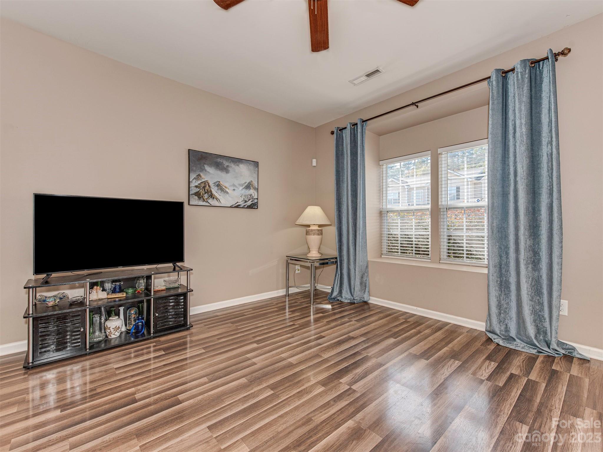 2049 Twilight Lane Monroe, NC 28110 - Photo 13 of 44 a view of a livingroom with wooden floor and a flat screen tv