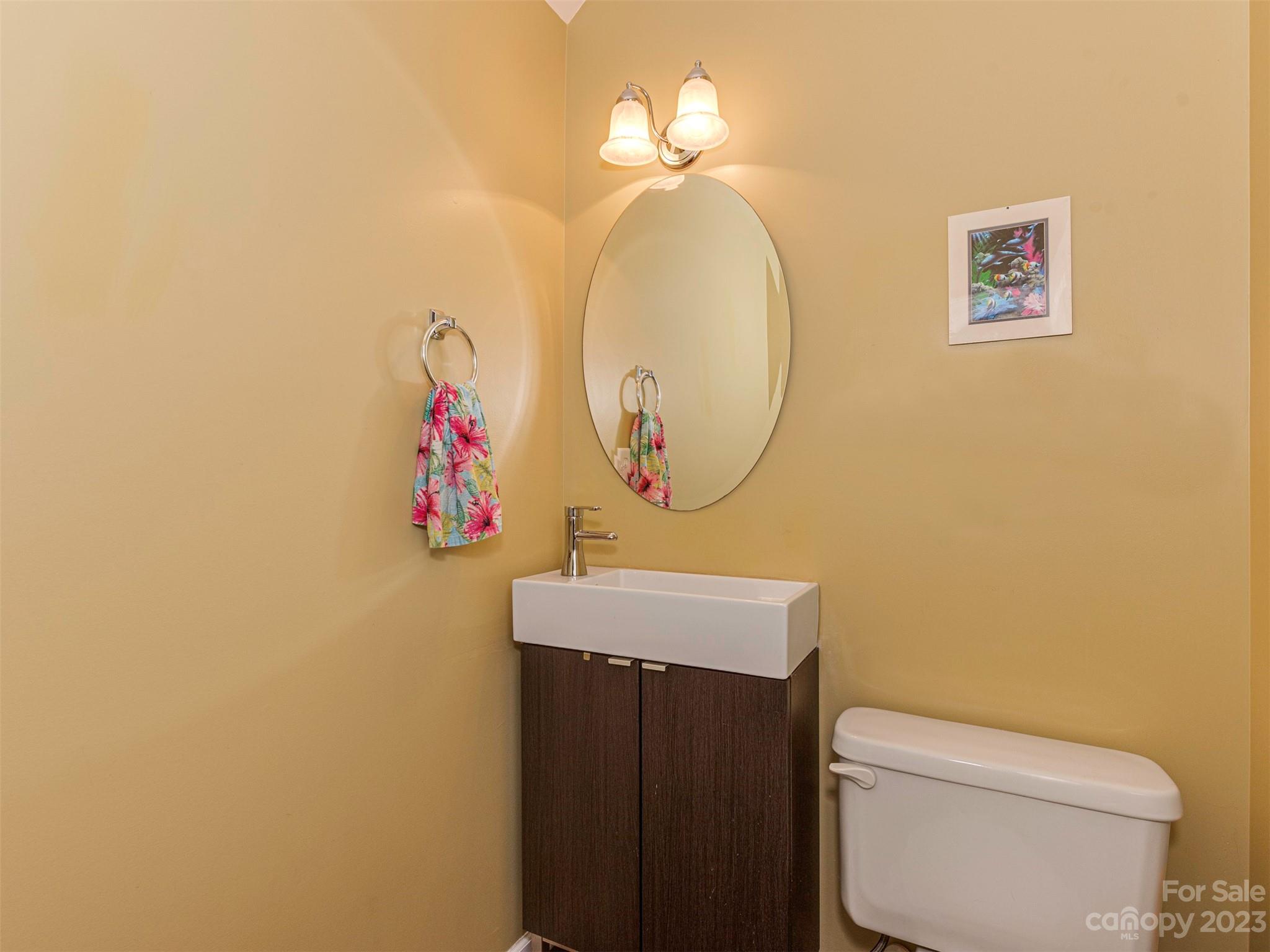 2049 Twilight Lane Monroe, NC 28110 - Photo 16 of 44 a bathroom with a toilet a sink and a mirror
