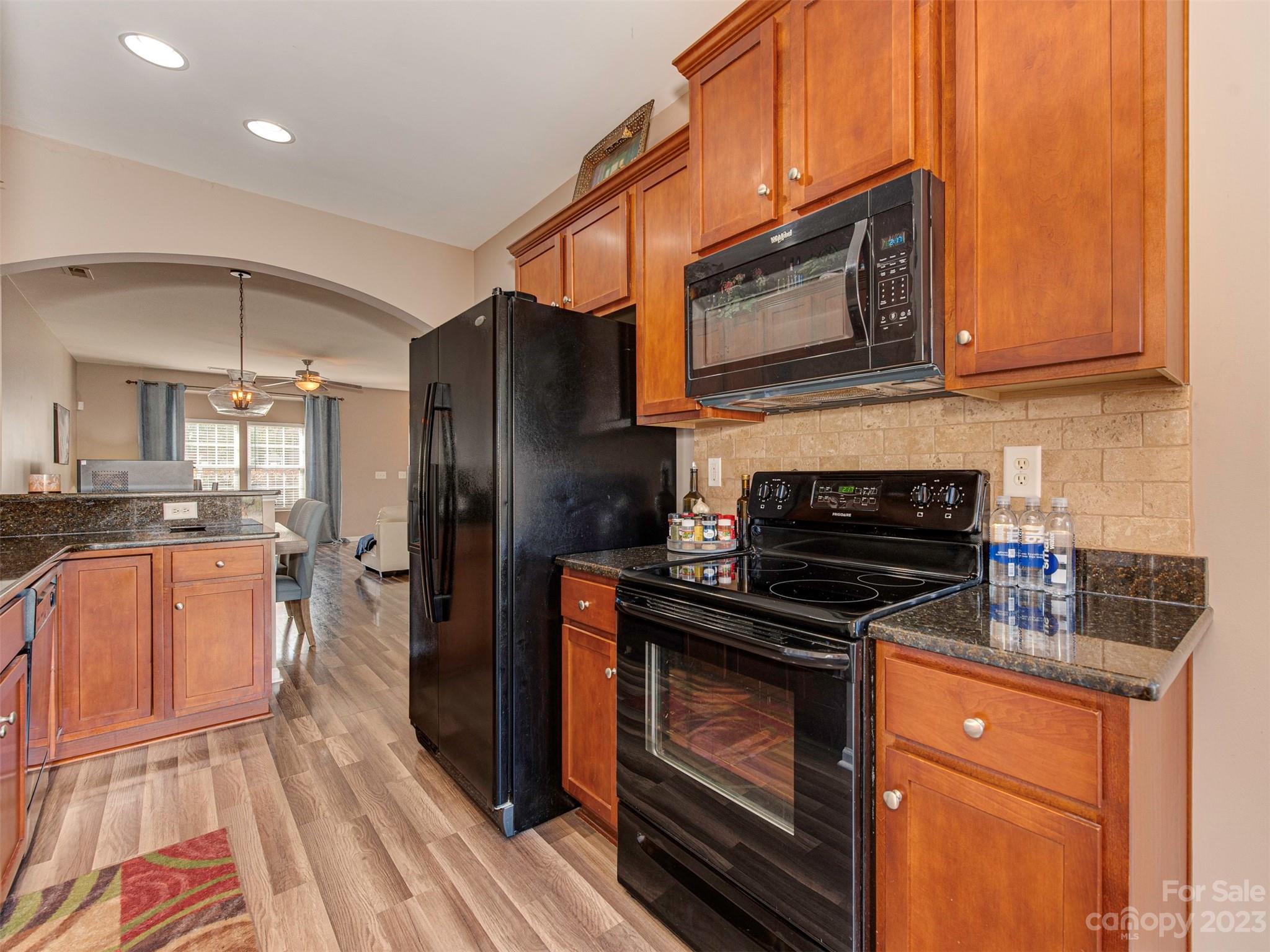 2049 Twilight Lane Monroe, NC 28110 - Photo 17 of 44 a kitchen with stainless steel appliances granite countertop a stove a sink and a microwave