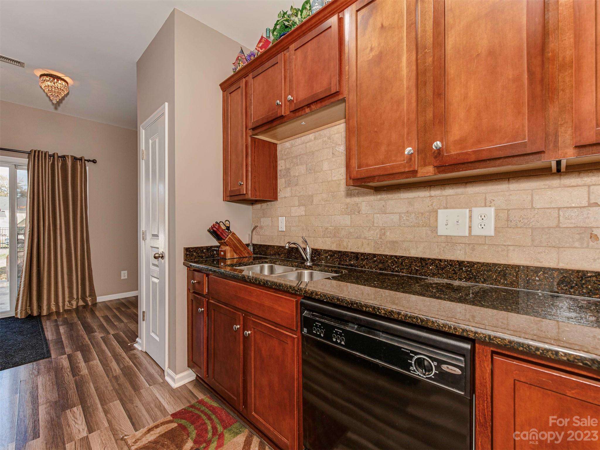 2049 Twilight Lane Monroe, NC 28110 - Photo 18 of 44 a kitchen with granite countertop a sink stove and cabinets