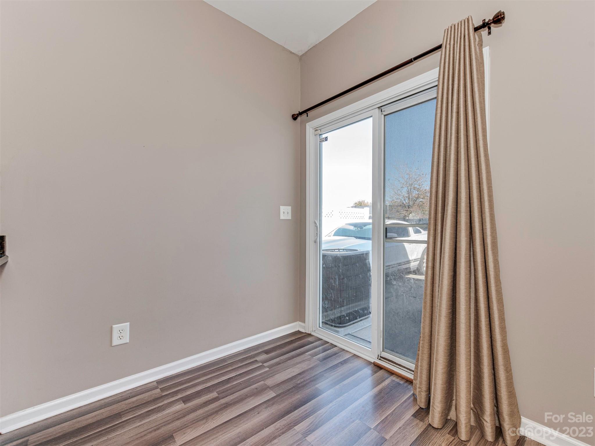 2049 Twilight Lane Monroe, NC 28110 - Photo 20 of 44 an empty room with wooden floor and windows