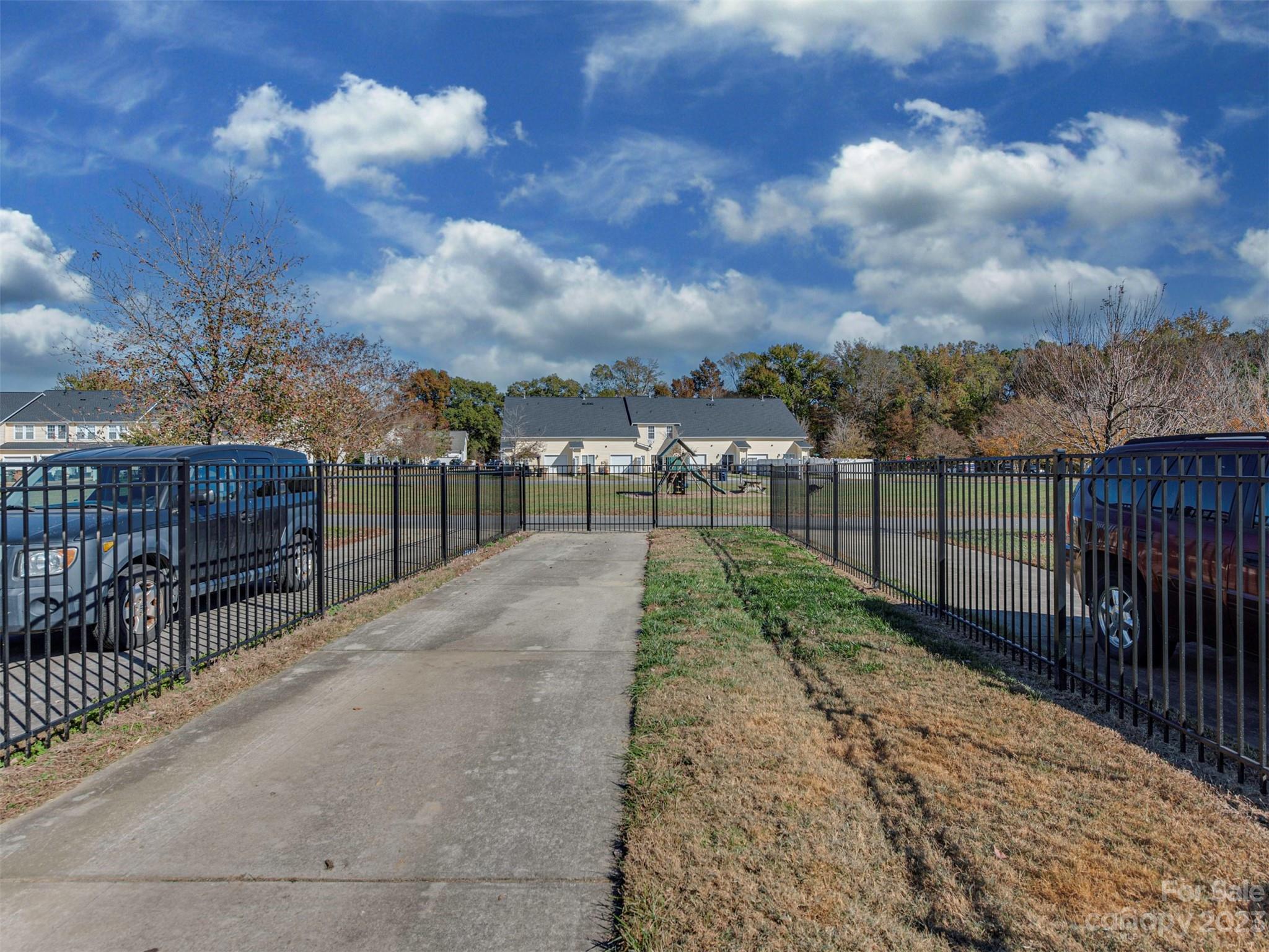 2049 Twilight Lane Monroe, NC 28110 - Photo 36 of 44 a view of a pathway with a wrought fence