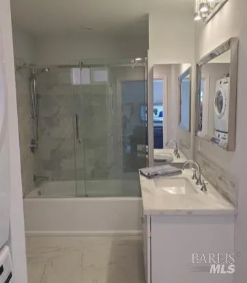 a bathroom with a bathtub a sink a mirror and a shower