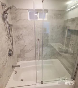 a bathroom with a bathtub and a shower
