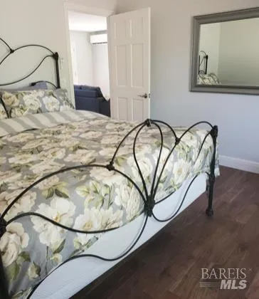 a bedroom with a bed and a painting on the wall