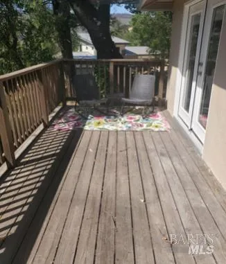 a view of backyard with a deck and wooden floor