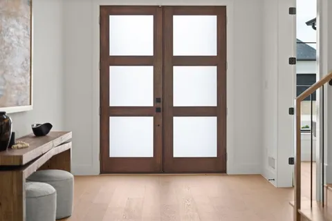 a view of an empty room with a window and bathroom