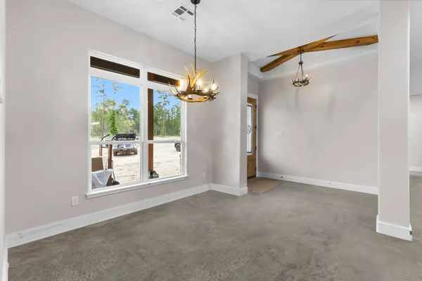 a view of a big room with a windows and brick walls