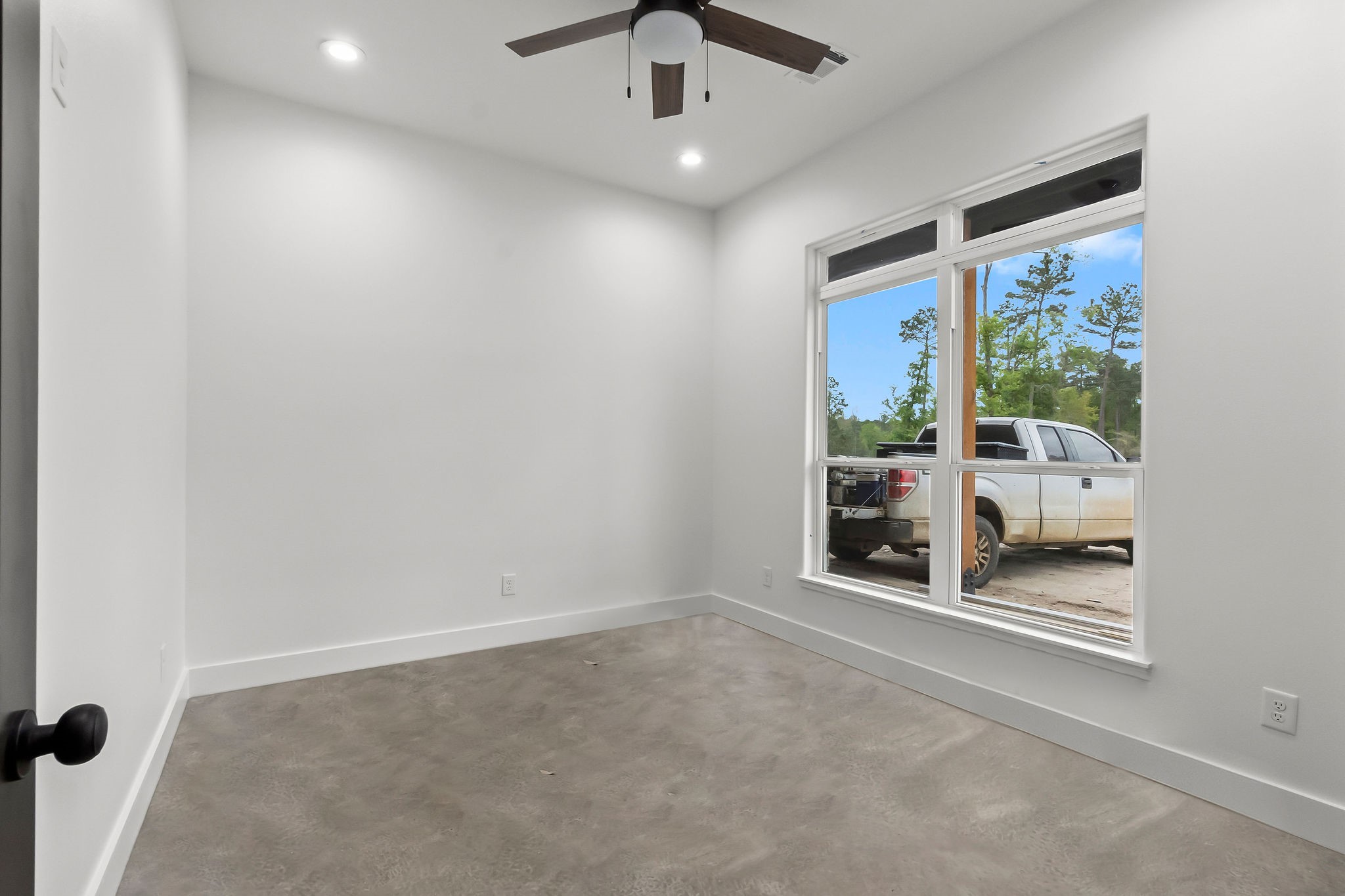 393 Hanson Road Onalaska, TX 77360 - Photo 18 of 38 wooden floor in an empty room with a window